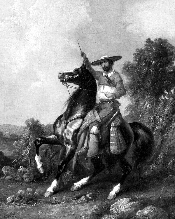 Charro a caballo con sombrero de ala ancha